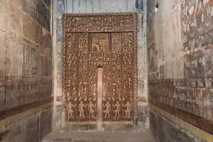 Ancient Egyptian hieroglyphs and wall paintings inside Saqqara tomb on a private Giza pyramids tour