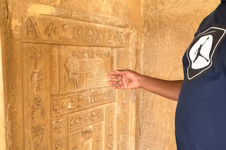 Close-up of carved Egyptian tomb reliefs at Saqqara necropolis on a private Giza Pyramids and Memphis day trip