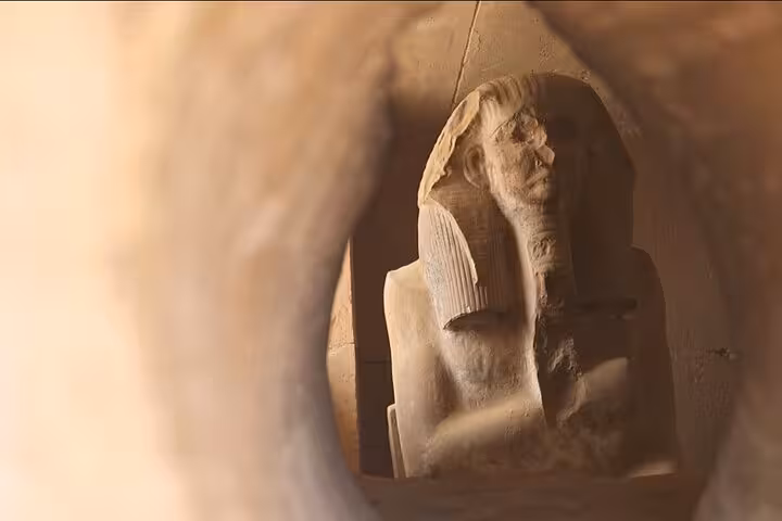 Ancient Egyptian statue inside Saqqara tomb chamber, highlight stop on Saqqara & Giza Pyramids tour