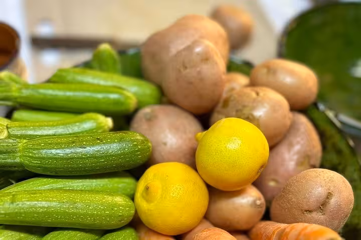 Fresh ingredients including zucchini, potatoes, lemons, and carrots for Sardin Tawa Cooking Class Marrakesh.