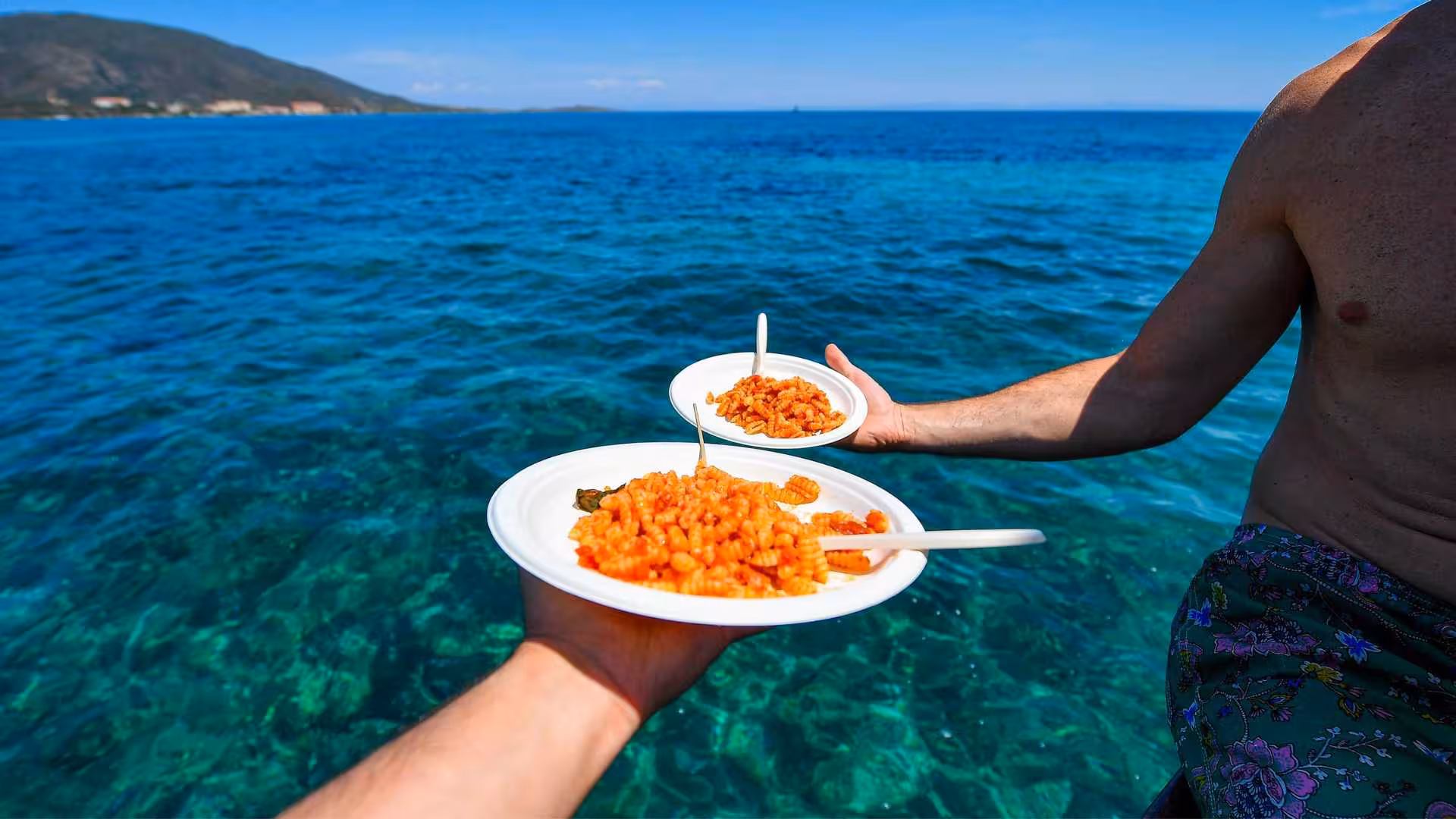 Sardinian pasta dishes enjoyed on a sailing trip near Asinara's crystal-clear waters, offering a taste of local cuisine.