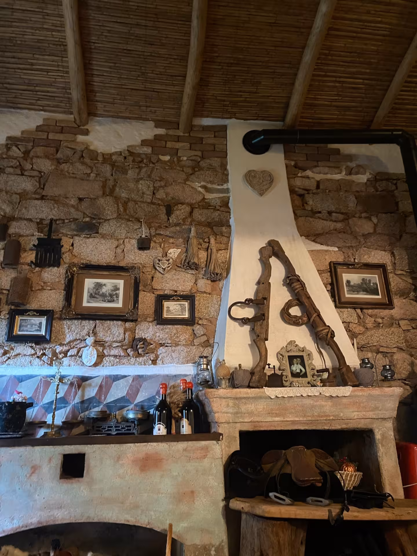 Rustic Sardinian kitchen decor with traditional artifacts in an ancient Olbia village setting.
