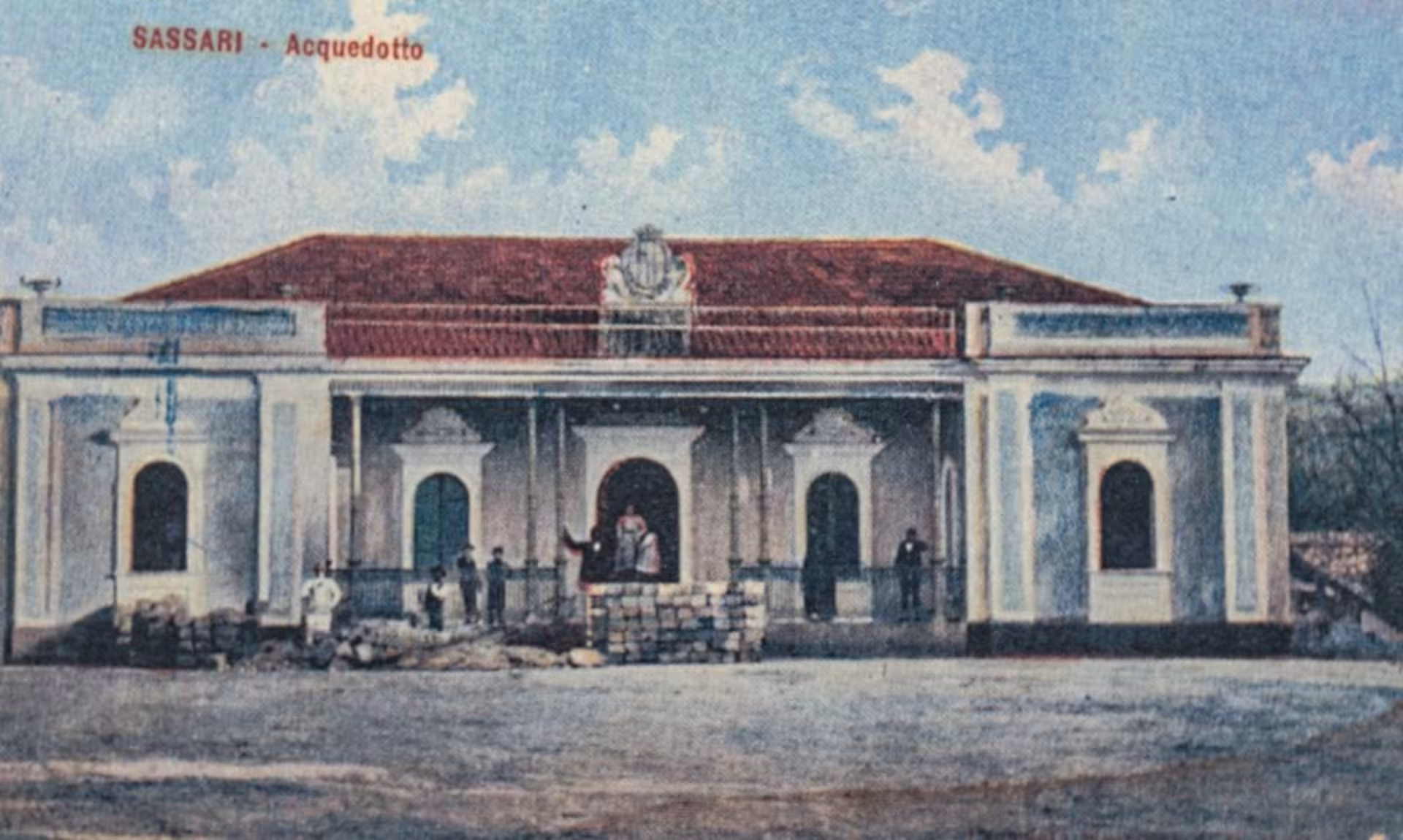 Historic postcard of Sassari's Acquedotto, capturing the architectural elegance of the water supply building.