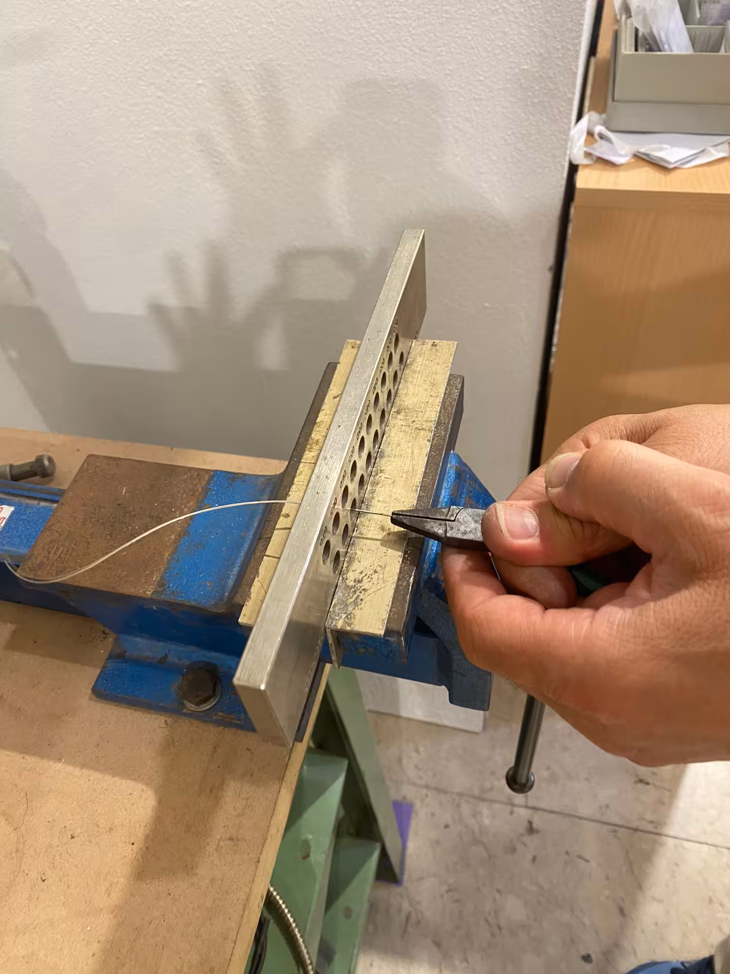 Close-up of precise metalwork in Sassari's filigree goldsmith workshop, highlighting intricate jewelry making.