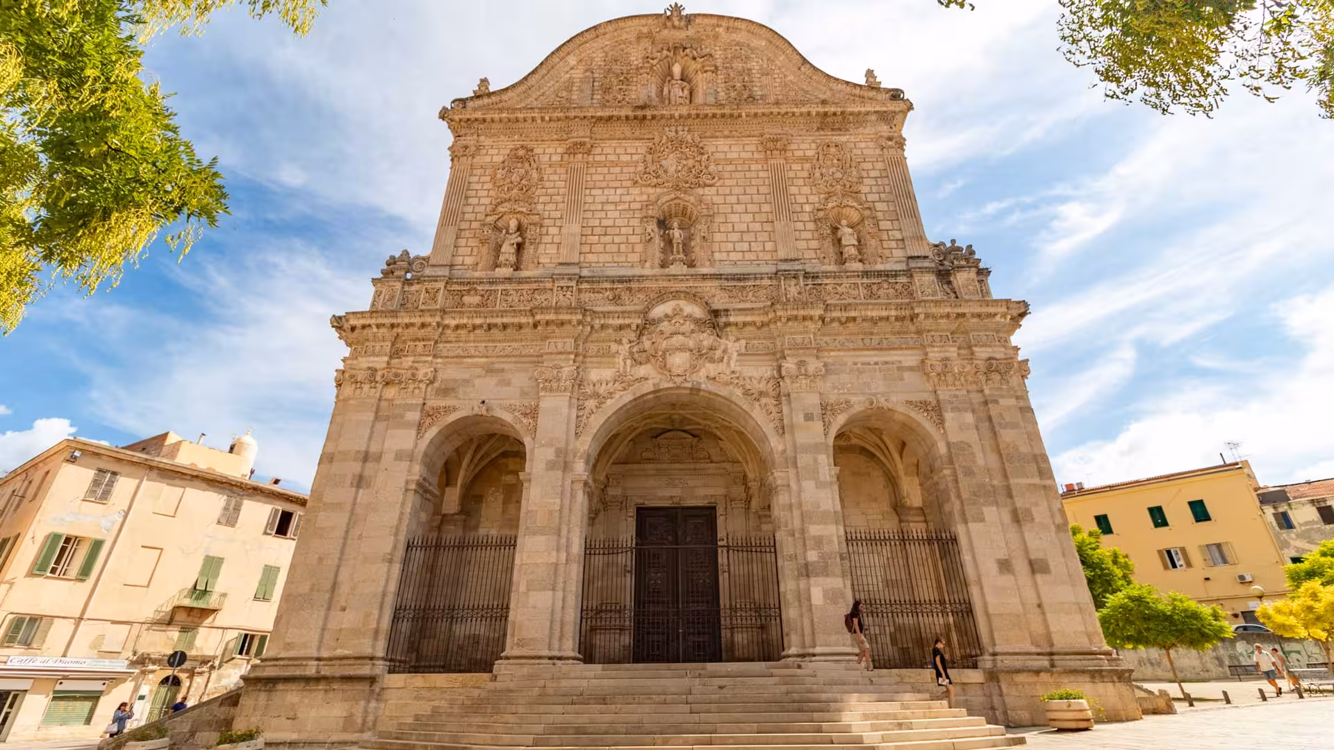 Ornate facade of a historic building in Sassari's center, showcasing intricate stone carvings.