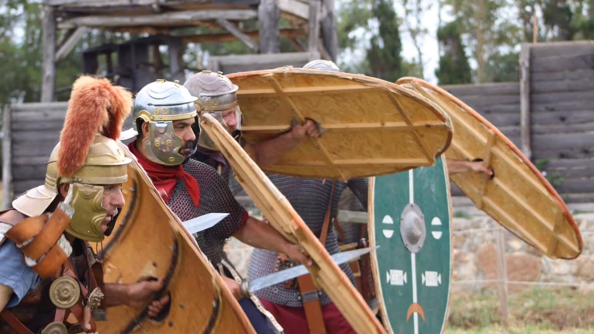 Reenactors in Roman armor demonstrate battle formations at the Sassari Roman Castrum, enhancing historical tours.