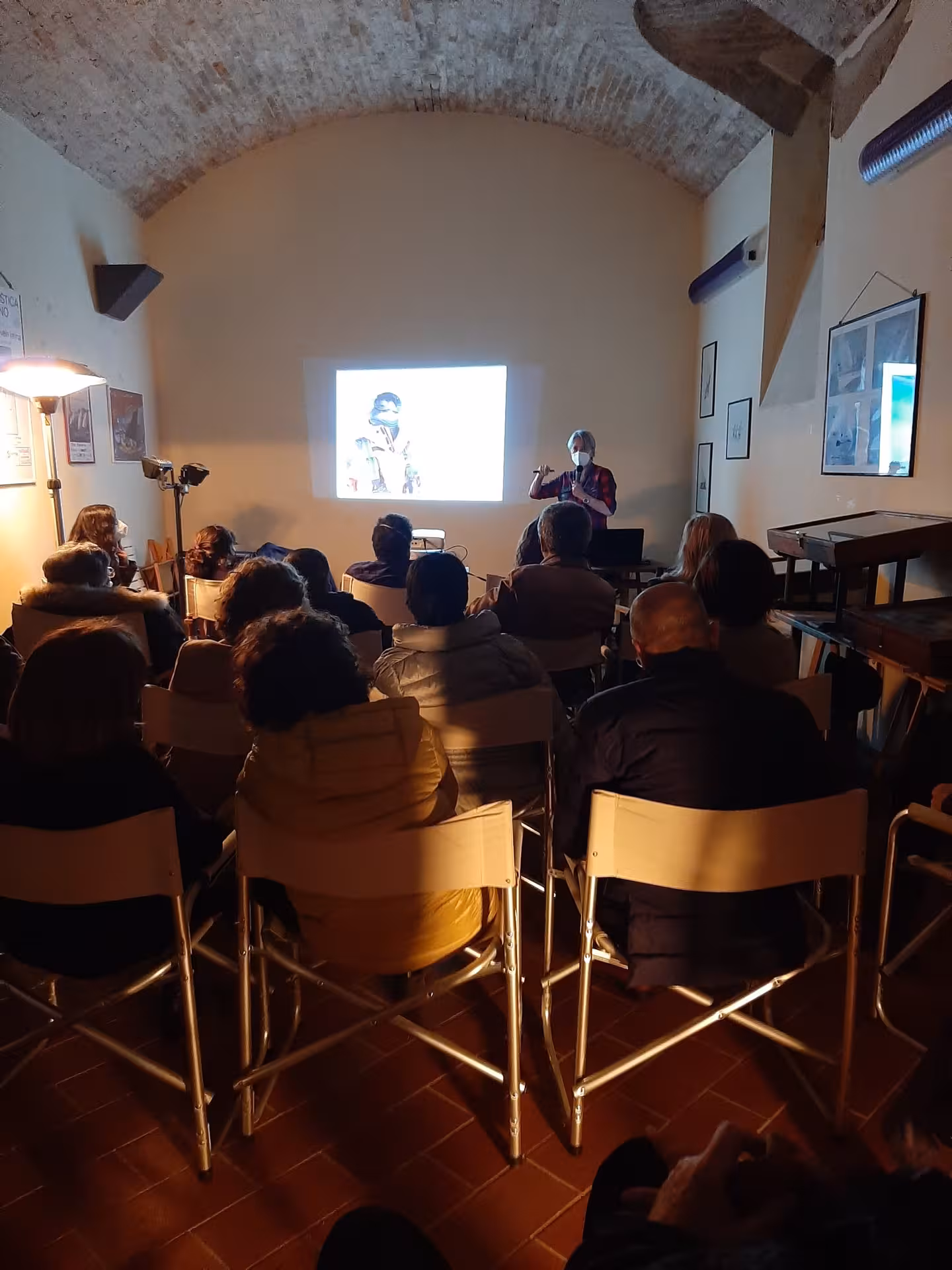 Visitors attending an engaging presentation at Sassari's Sea and Water Ecomuseum, showcasing marine conservation.