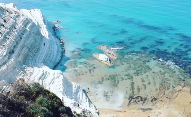 Aerial view of Scala dei Turchi white cliffs and turquoise sea near Agrigento on a private Palermo coastal tour