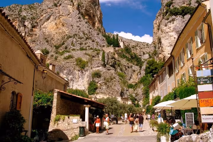 Scenic village nestled in the rocky landscape near the Grand Canyon of Europe, bustling with tourists.