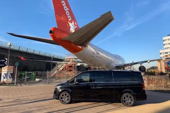 Schiphol Airport to Amsterdam private transfer minivan with meet and greet, chauffeur service near aircraft