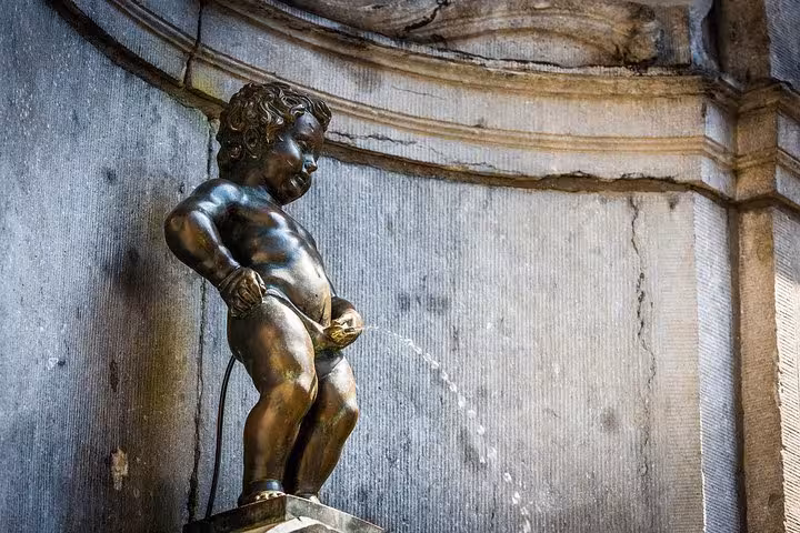 Manneken Pis fountain in Brussels, a must-see stop after Schiphol Airport private transfer service