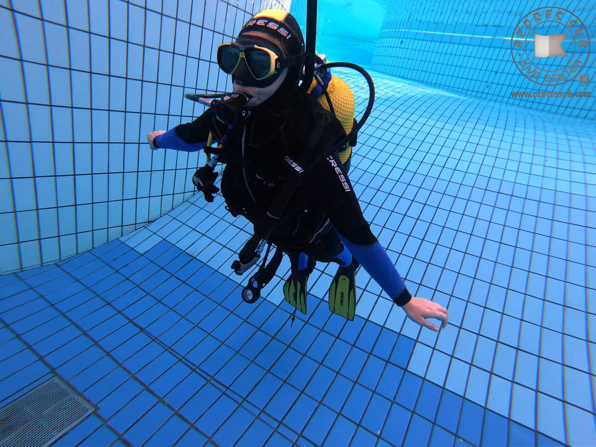 Scuba diver practicing buoyancy in a tiled swimming pool, ideal for baptism in a pool beginner dive session