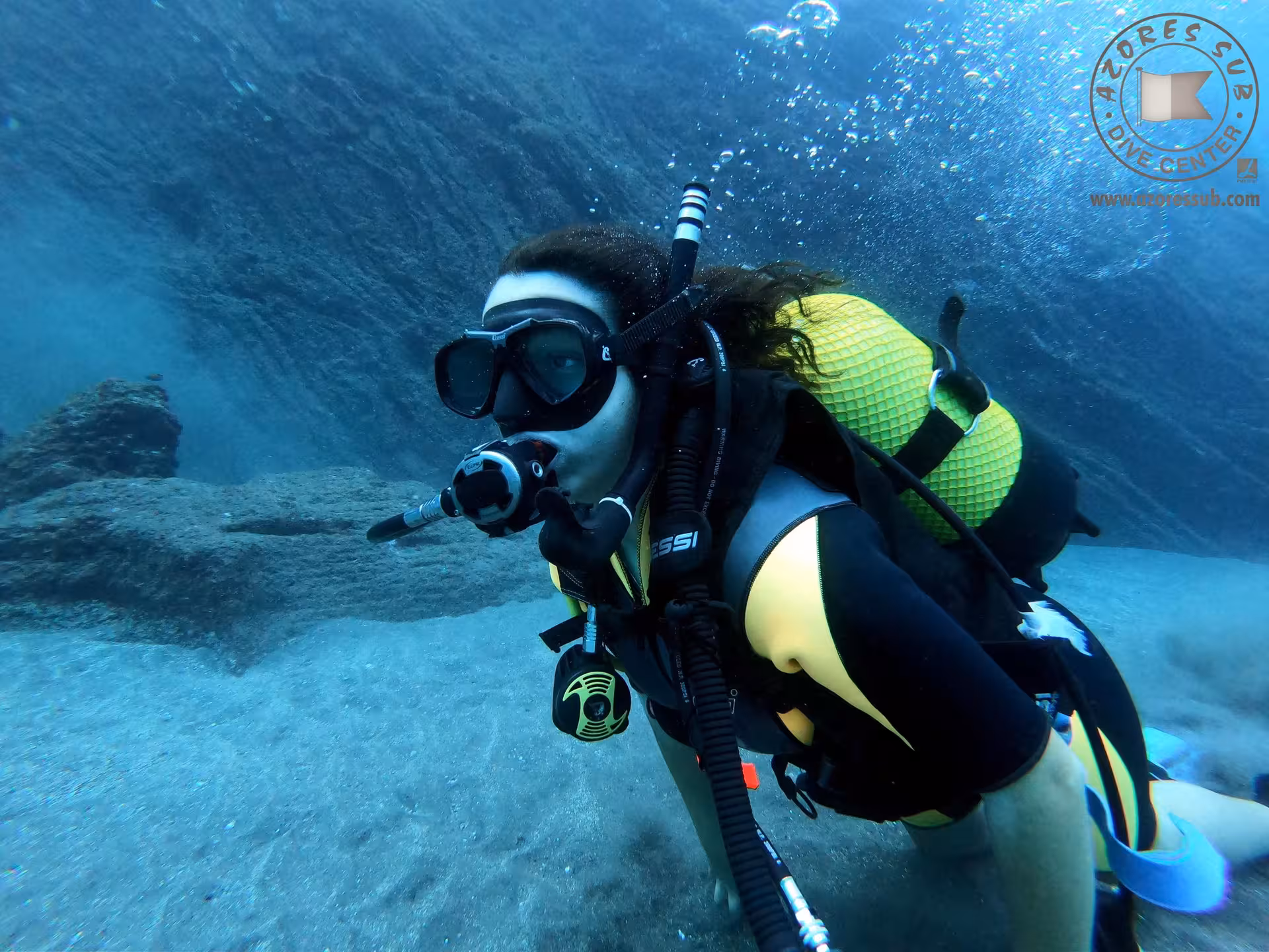 Scuba diver glides over sandy bottom during Refresh Dive, rebuilding confidence with guided skills and buoyancy
