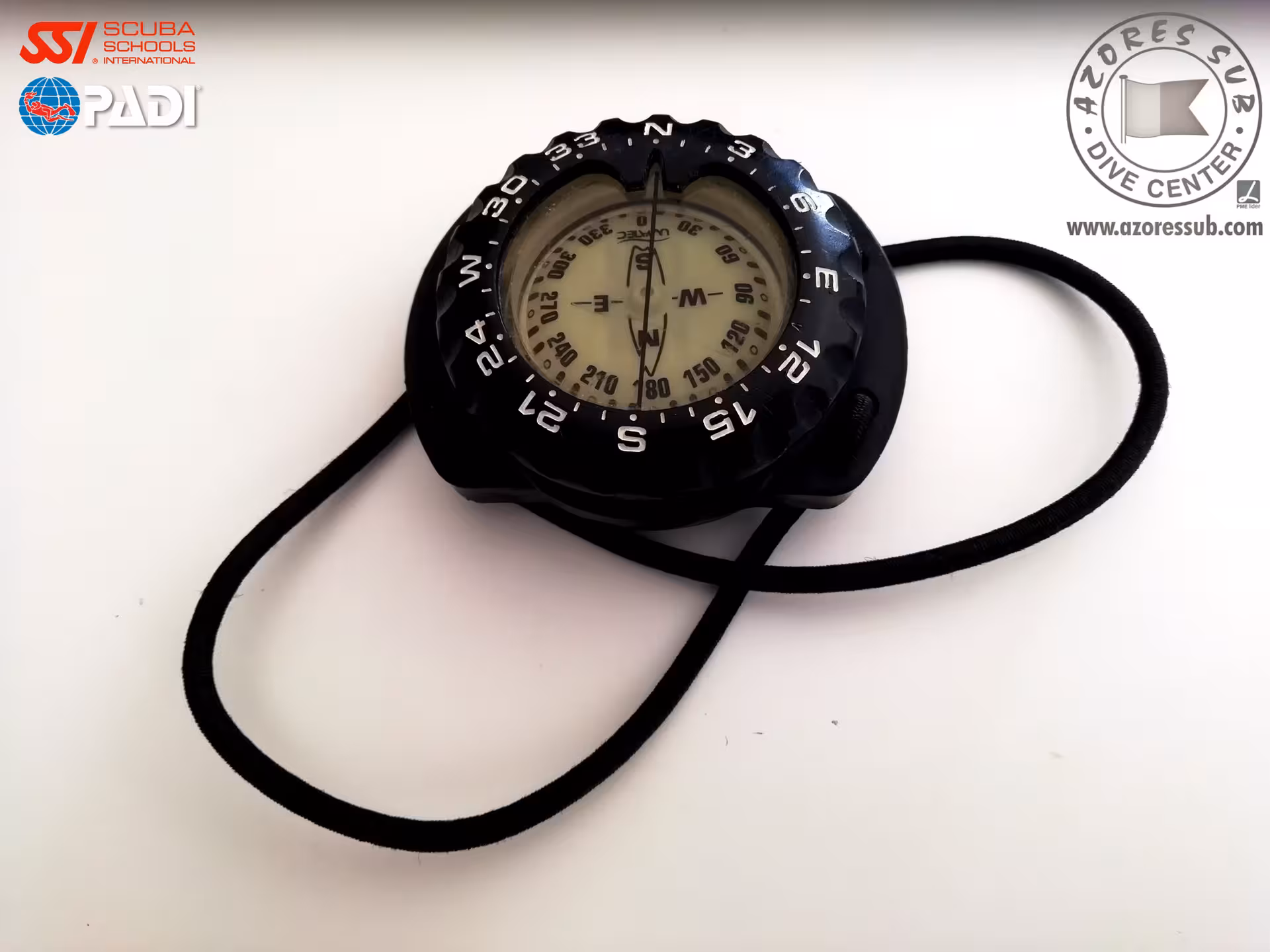 Close-up of scuba navigation compass on lanyard, essential gear for PADI Underwater Navigation Specialty São Miguel Azores