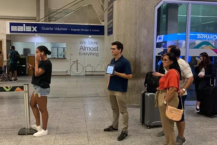 Travelers waiting at SDU Airport for private transport to Rio de Janeiro hotels, showcasing convenient transfer services.