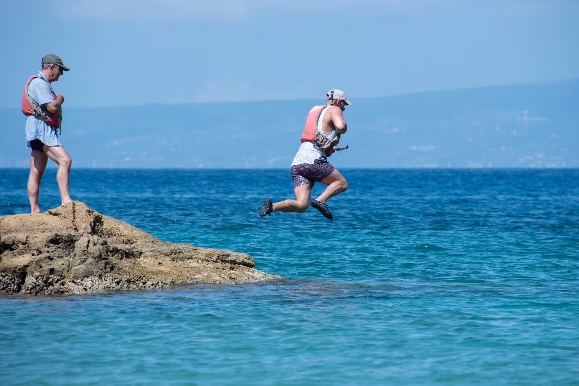 Kayaking tour in Kalamata with a cliff jump into clear blue water on the Messinian Gulf coastline