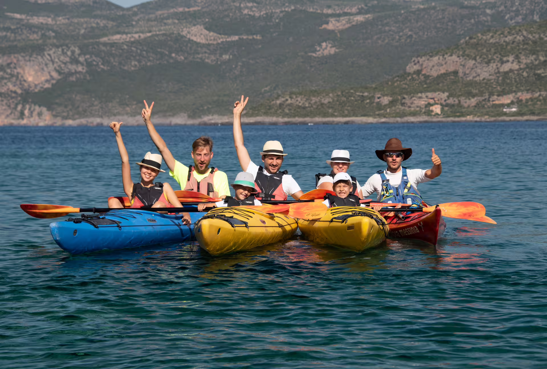 Group sea kayaking in Kardamyli and Stoupa with colorful kayaks on the Mani coast, Peloponnese Greece