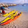 Colorful sea kayaks lined on La Ciotat beach before a Calanques guided kayaking excursion on the Mediterranean