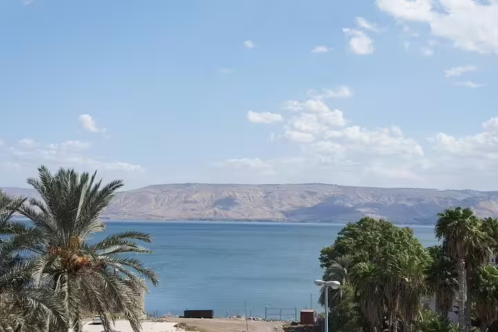 Panoramic view of the Sea of Galilee near Tiberias with palms and hills on a private day trip from Tel Aviv
