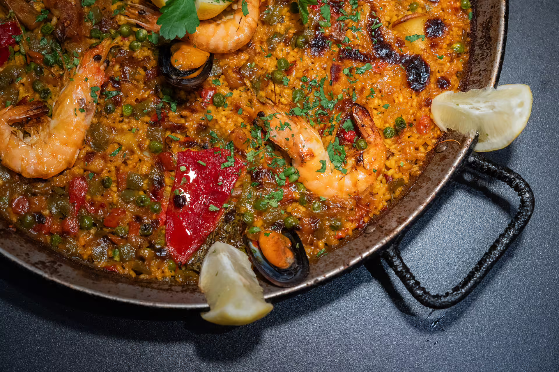 Close-up of a vibrant seafood paella dish with shrimp and mussels, served at Tablao Cordobes in Barcelona.