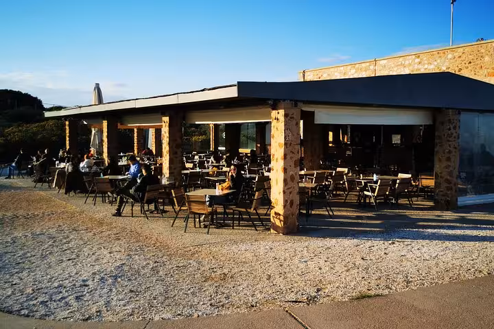 Seaside café stop on the Athenian Riviera en route to Cape Sounio, part of a luxury private sunset tour