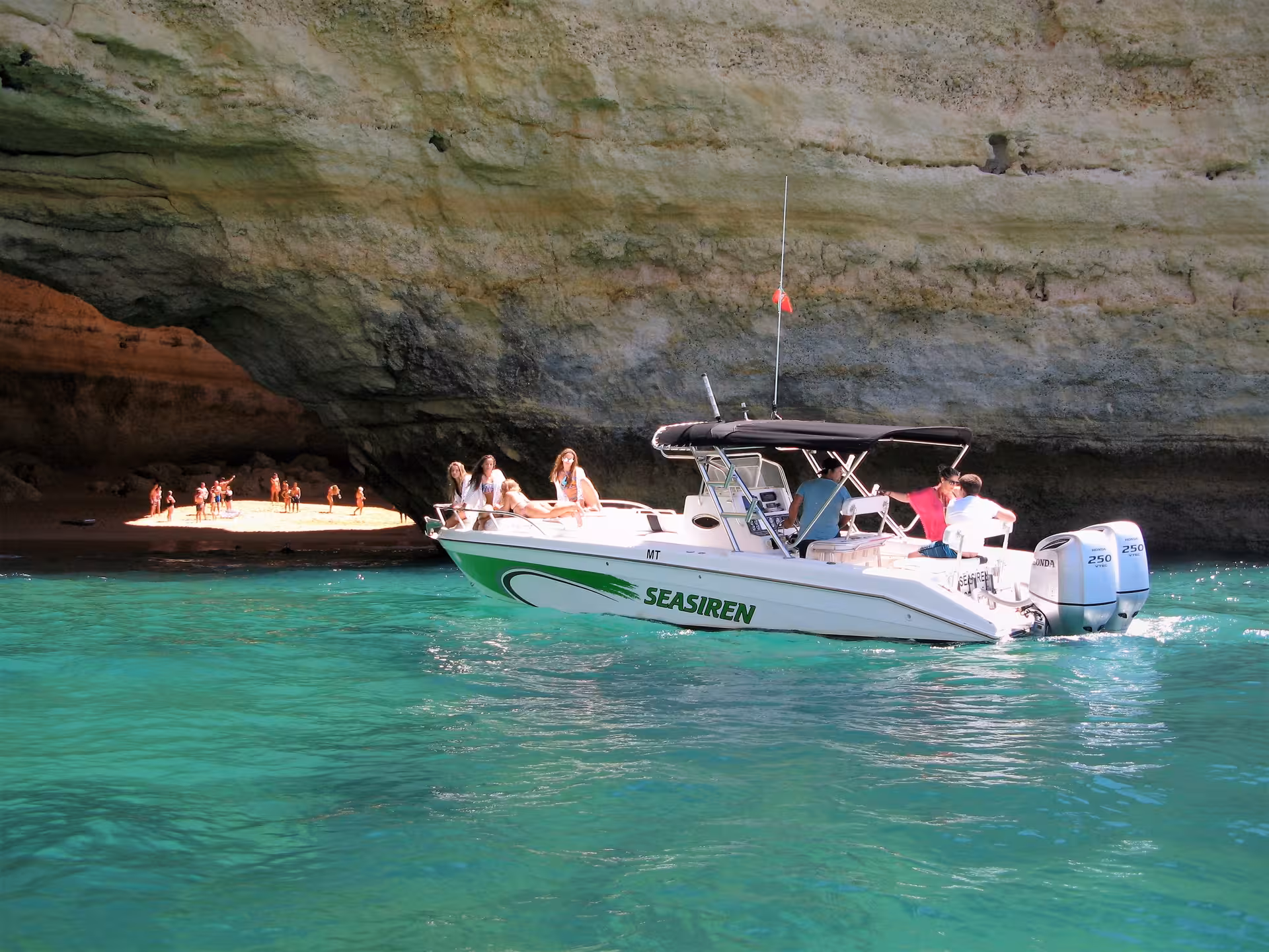 Guests relaxing on Seasiren speedboat near Benagil Cave, exploring Algarve coastline and secluded beach on a 3-hour private tour