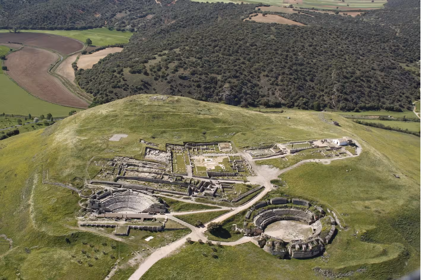 Aerial view of Segóbriga Roman amphitheatre and theatre ruins, popular day trip to Roman Empire from Madrid