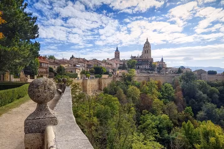 Scenic view of Segovia's historic architecture and lush greenery on a day trip from Madrid.