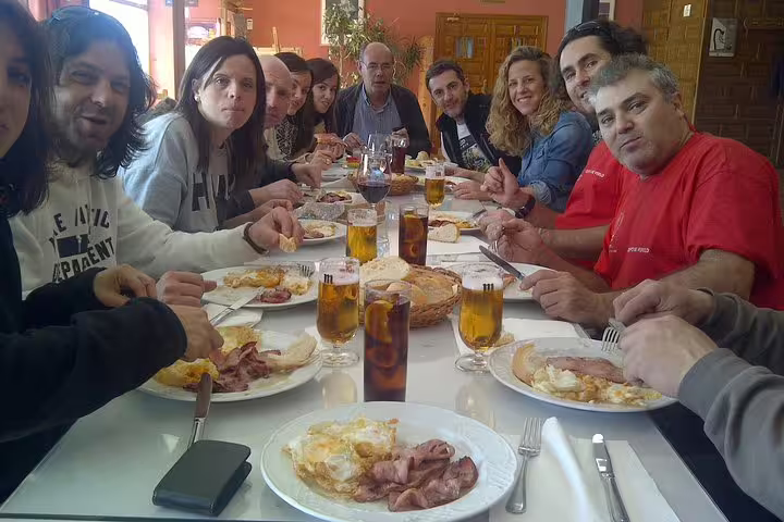 Travelers enjoying a traditional Spanish meal together after a thrilling Segovia balloon ride experience.