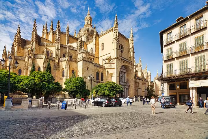 The majestic Segovia Cathedral stands in a bustling plaza, a must-see on the Segovia and Avila day tour from Madrid.