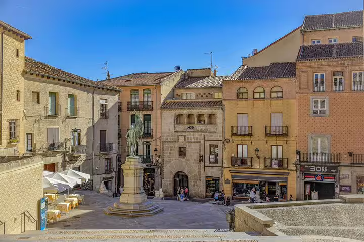 Plaza in Segovia Old Town with statue and historic facades on half-day private minivan tour
