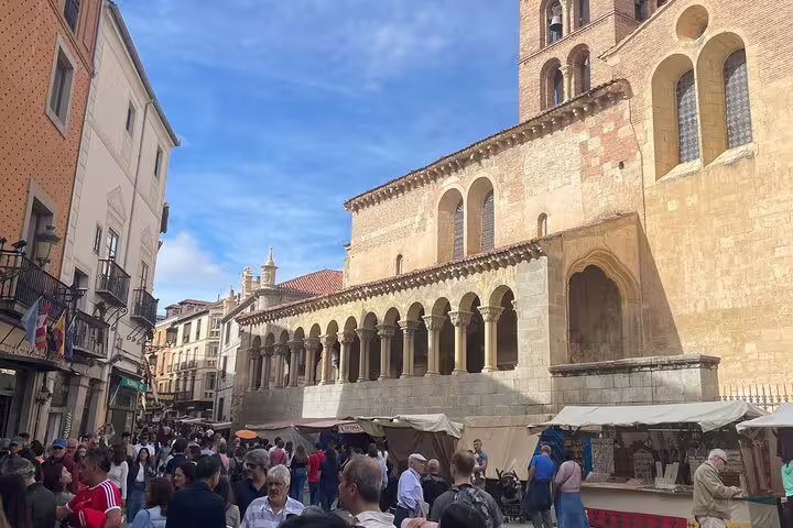 Crowds at Segovia Plaza Mayor by San Martín Church, visited on private minivan tour from El Escorial to Segovia