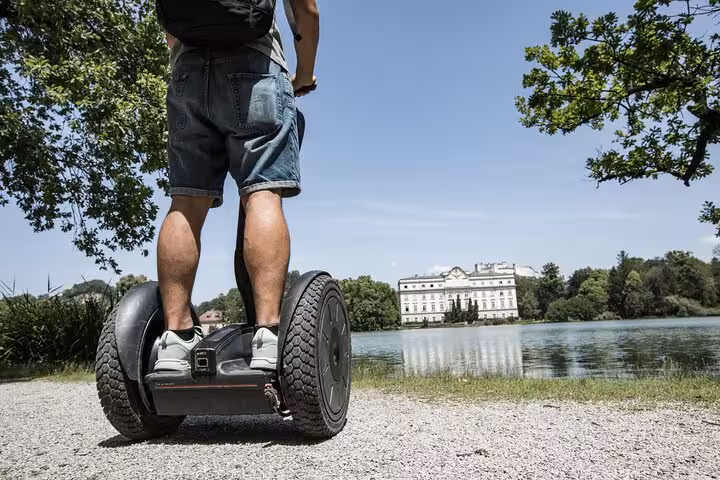 Person on Segway overlooking scenic lake view at Salzburg city tour.