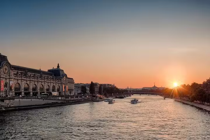 Seine River sunset near Musée d’Orsay, private Paris by night tour with scenic riverside views