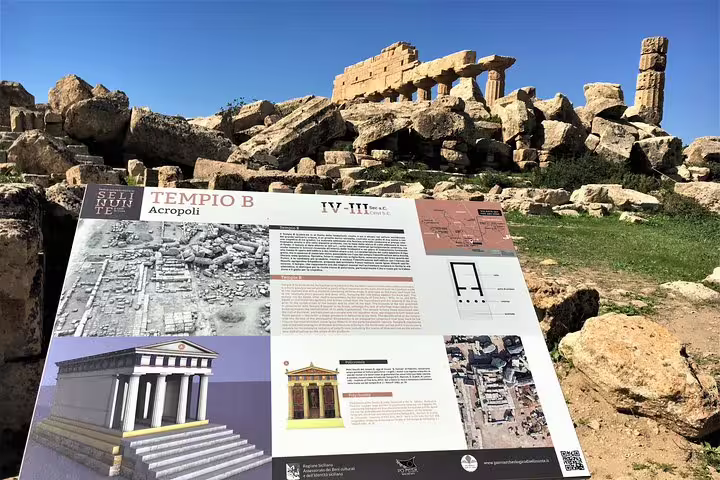 Informative Tempio B signboard with ancient temple ruins behind at Selinunte Archaeological Park on a Palermo day trip