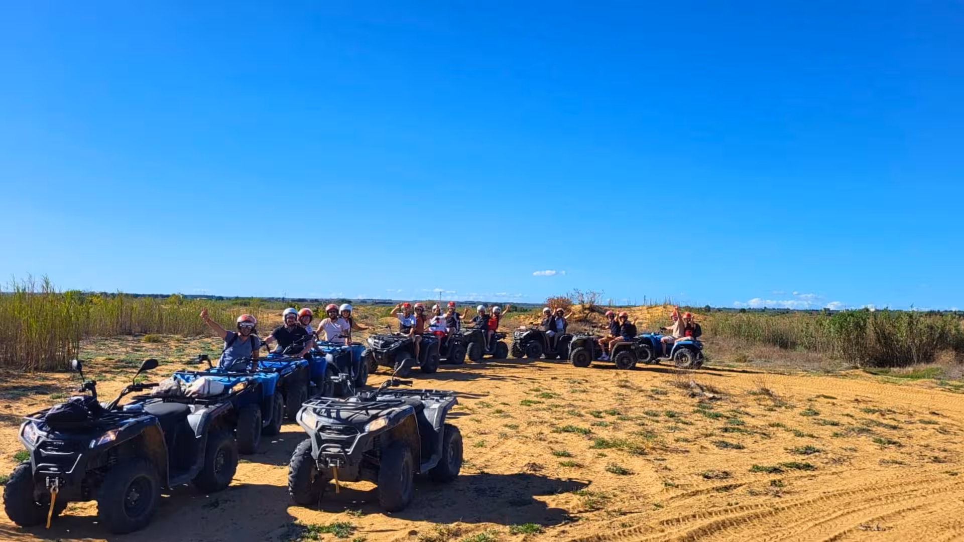 Adventurers on ATVs enjoying the vast open landscapes of Triscina dunes during Selinunte's thrilling 3-hour tour.