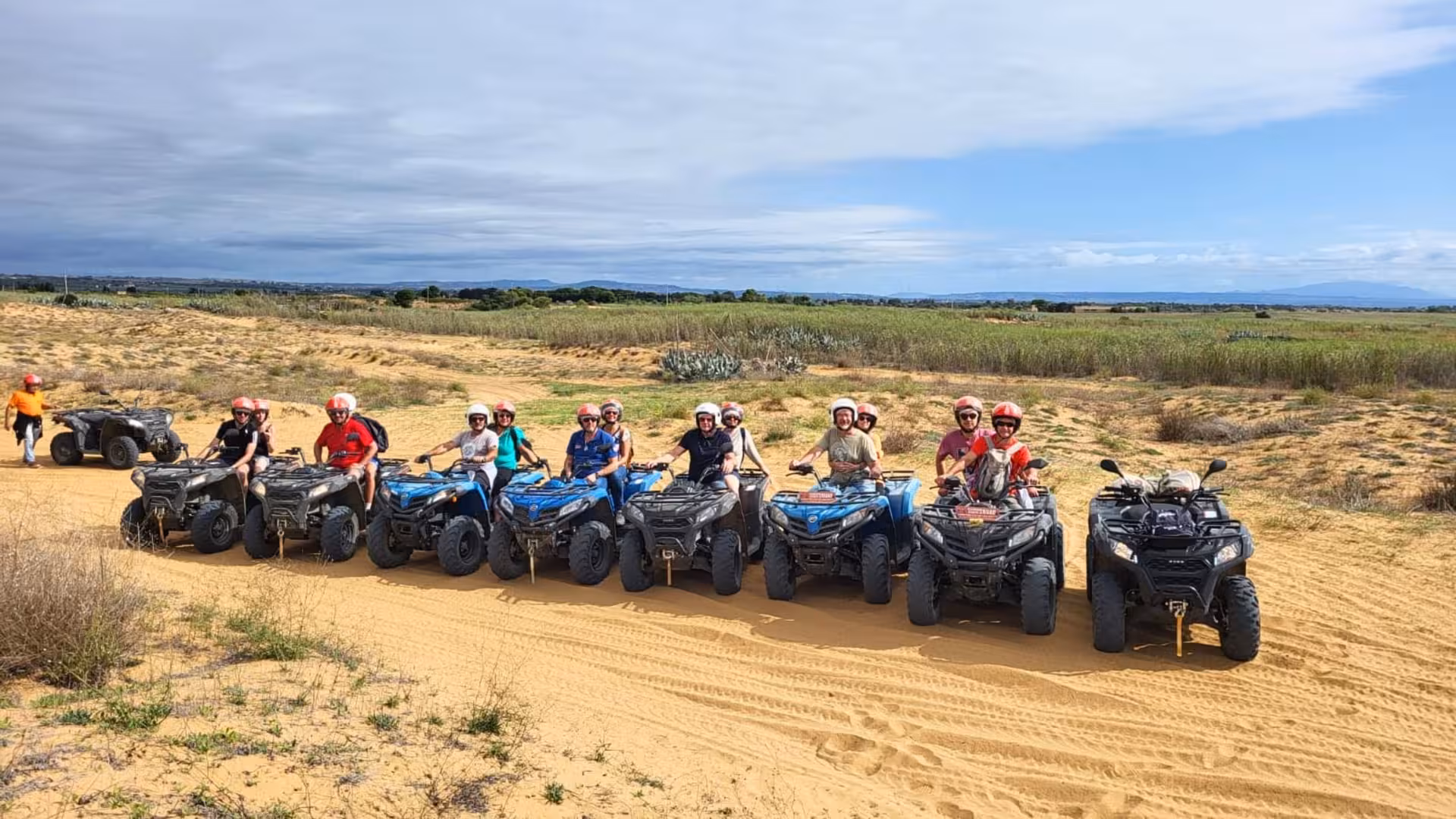 Group of riders on ATVs exploring the sandy Triscina dunes during a 3-hour Selinunte adventure tour.