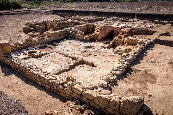 Excavated stone foundations and ancient quarry remains at Cave di Cusa, showcasing Greek ruins on a private tour from Palermo