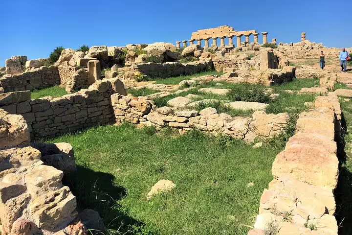 Ancient stone ruins and Greek temple columns at the Archaeological Park of Selinunte on a sunny Sicily private tour