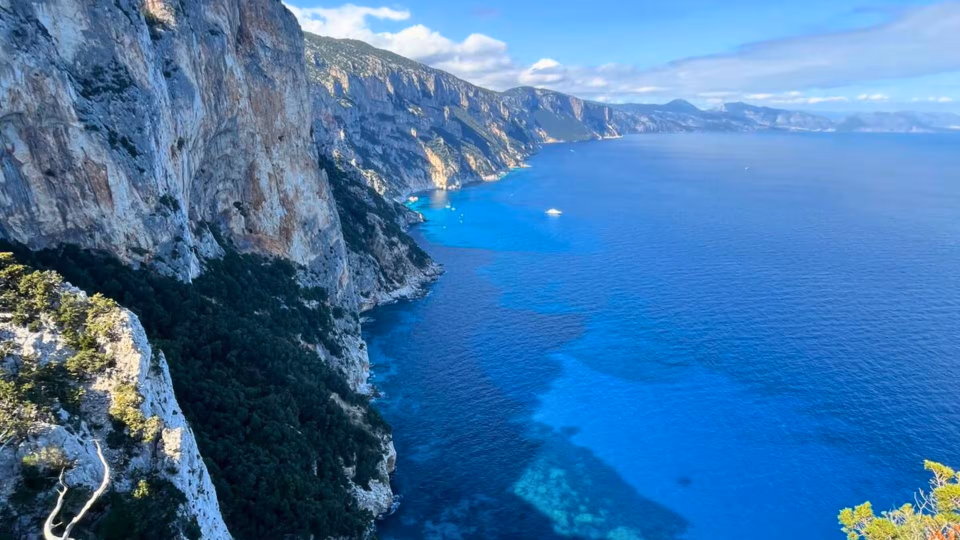 Stunning coastal cliffs and azure waters of Sardinia along the Selvaggio Blu trekking route.