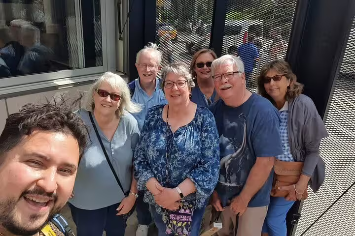 Group of tourists enjoying a Semi-Private Barcelona Tour, capturing a memorable moment with their guide.