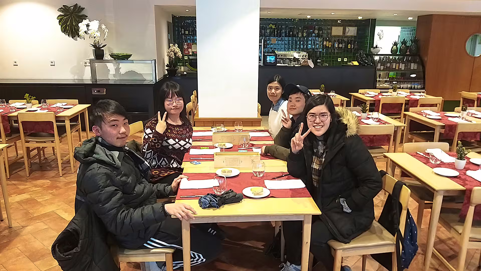 A group of tourists enjoying a meal at a cozy restaurant during the Serra da Estrela Park cheese tour.