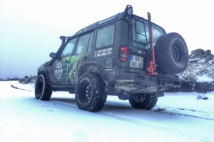Off-road vehicle on a snowy trail in Serra da Estrela, perfect for adventure tours and cheese tasting experiences.