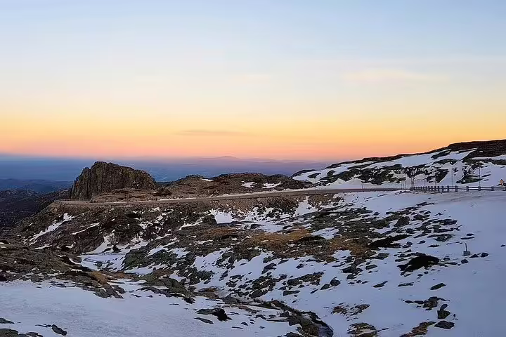 Stunning sunset over snow-capped peaks in Serra da Estrela, a highlight of private tours from Lisbon.
