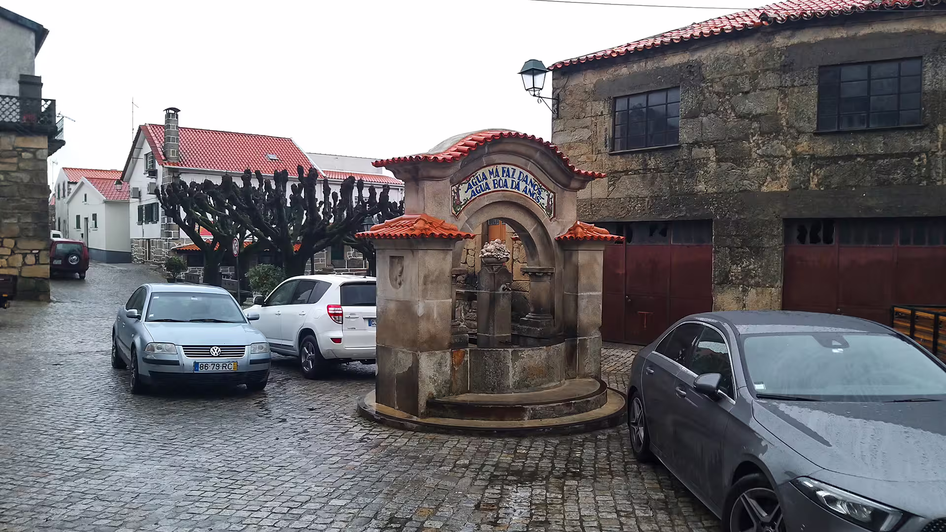 Charming village square with historic fountain in Serra da Estrela Park, ideal stop on a private cheese tasting tour.
