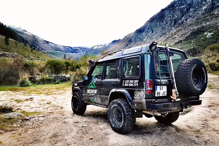 Off-road tour jeep parked in the scenic Serra da Estrela mountains, perfect for adventurous cheese tasting tours.