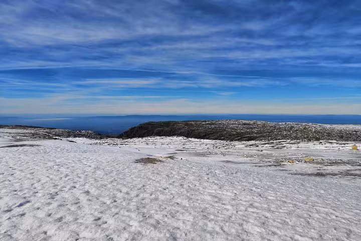 Wide snowfield on Serra da Estrela plateau with Atlantic horizon views on Portugal Snow winter excursion
