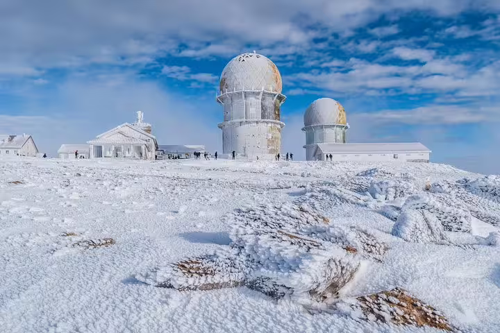 Stunning snowy scene of the iconic observatory towers in Serra da Estrela, perfect for winter adventure enthusiasts.