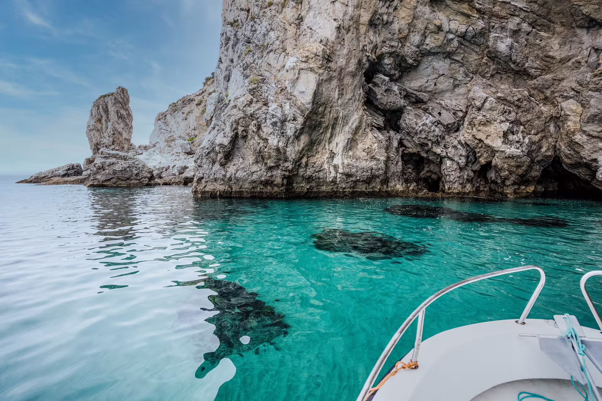 Explore the stunning turquoise waters and rugged cliffs of Sesimbra's Arrábida Park on a private boat tour adventure.