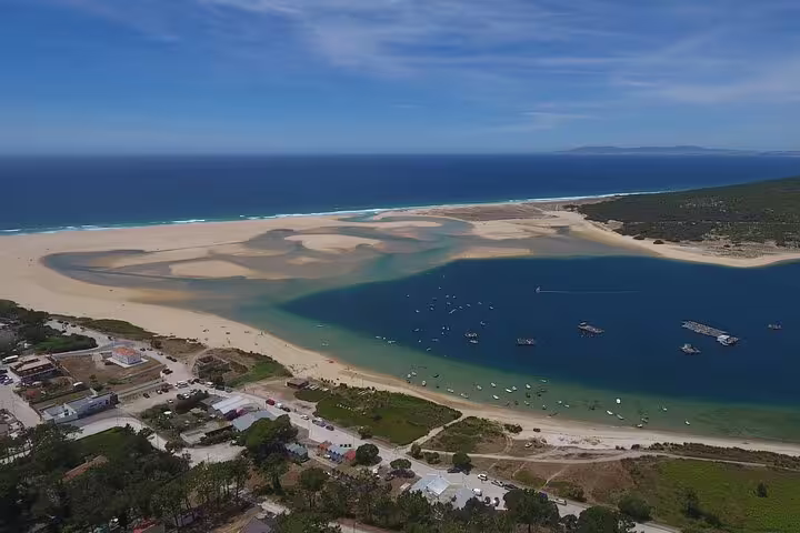Aerial view of the stunning Sesimbra lagoon with clear blue waters and sandy shores, perfect for an easy kayak adventure.